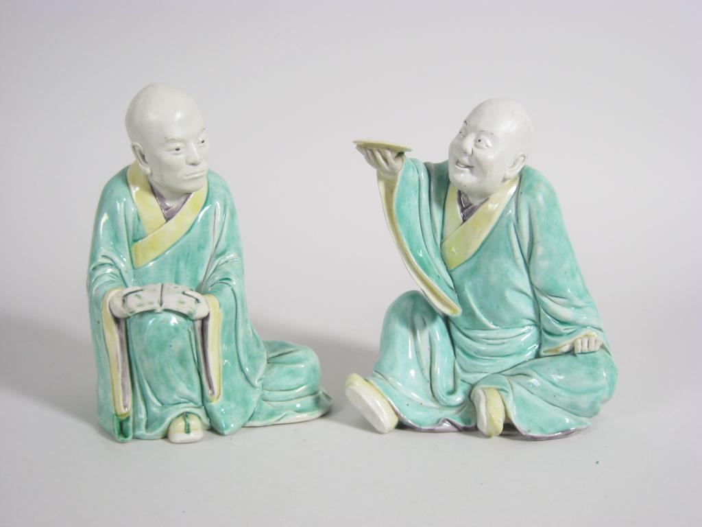 Appraisal: Pair of Chinese porcelain Seated Figures wearing green and yellow