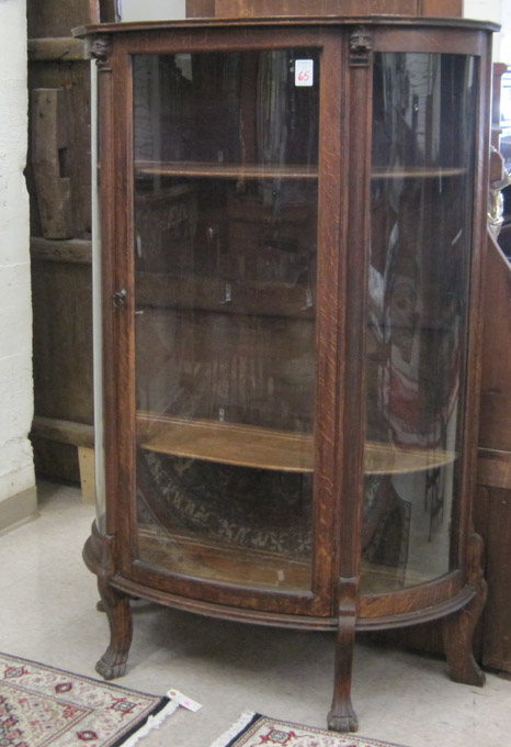 Appraisal: AN OAK AND CURVED GLASS CHINA DISPLAY CABINET American late