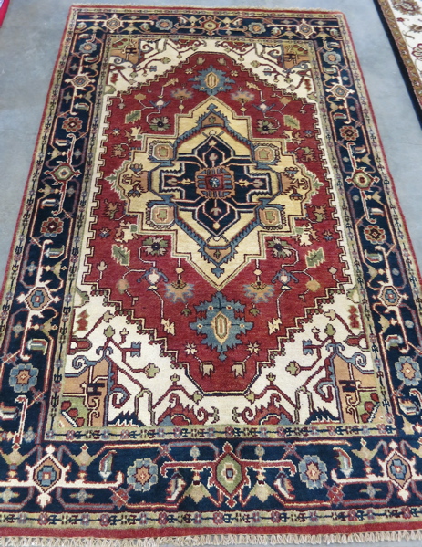 Appraisal: HAND KNOTTED ORIENTAL CARPET Persian Serapi design the hexagonal brick-red