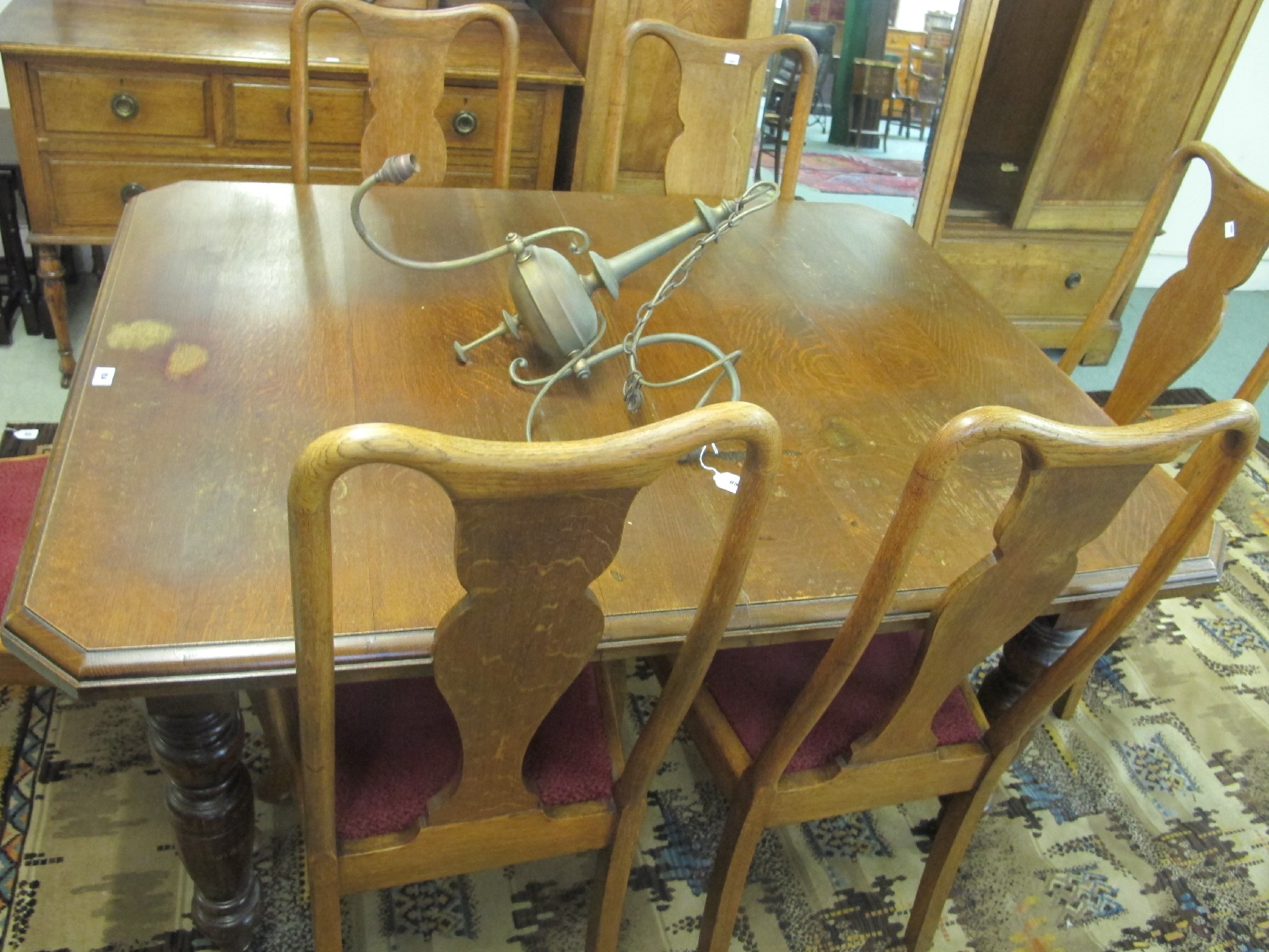 Appraisal: An oak wind-out dining table with six chairs