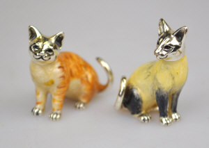 Appraisal: A pair of enamelled silver miniature cats