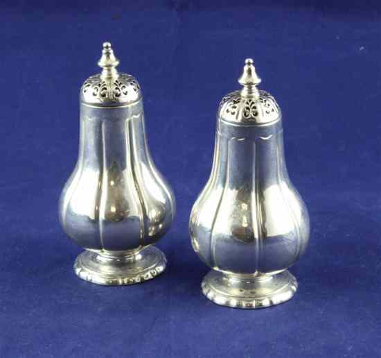 Appraisal: A pair of Victorian silver pepperettes of fluted pear shape