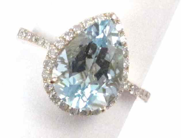 Appraisal: AQUAMARINE AND DIAMOND RING k yellow gold with round-cut diamonds