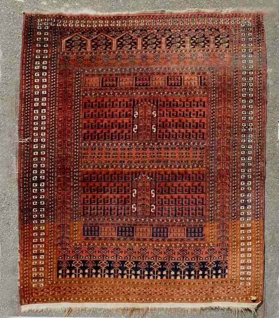 Appraisal: A TURKOMAN MID RED GROUND RUG decorated a central panel