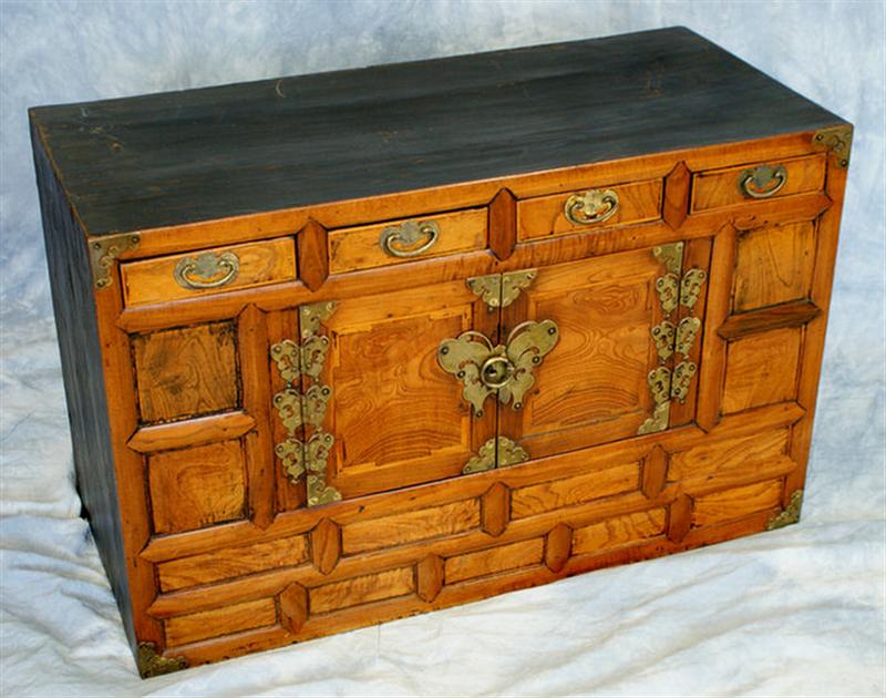 Appraisal: Oriental camphor wood chest with drawers over doors with brass