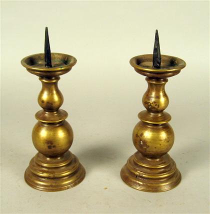 Appraisal: Pair of Continental brass prickets With baluster form stems on