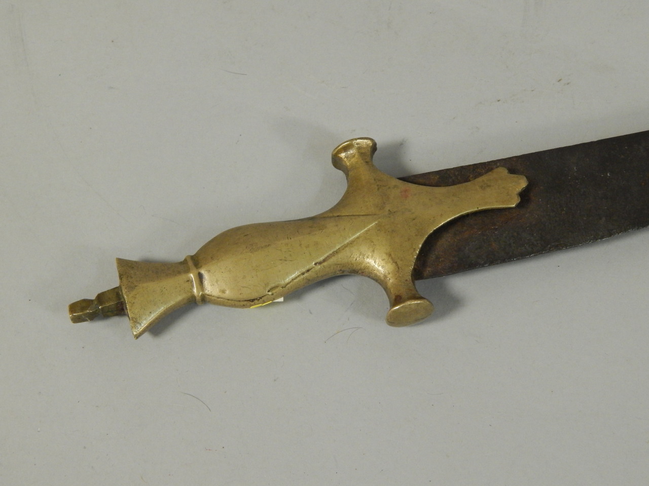 Appraisal: A thC Indian Talwar with a brass handle incomplete cm