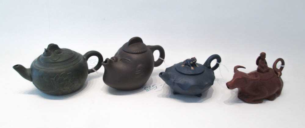 Appraisal: FOUR ASIAN POTTERY TEAPOTS including one in the shape of