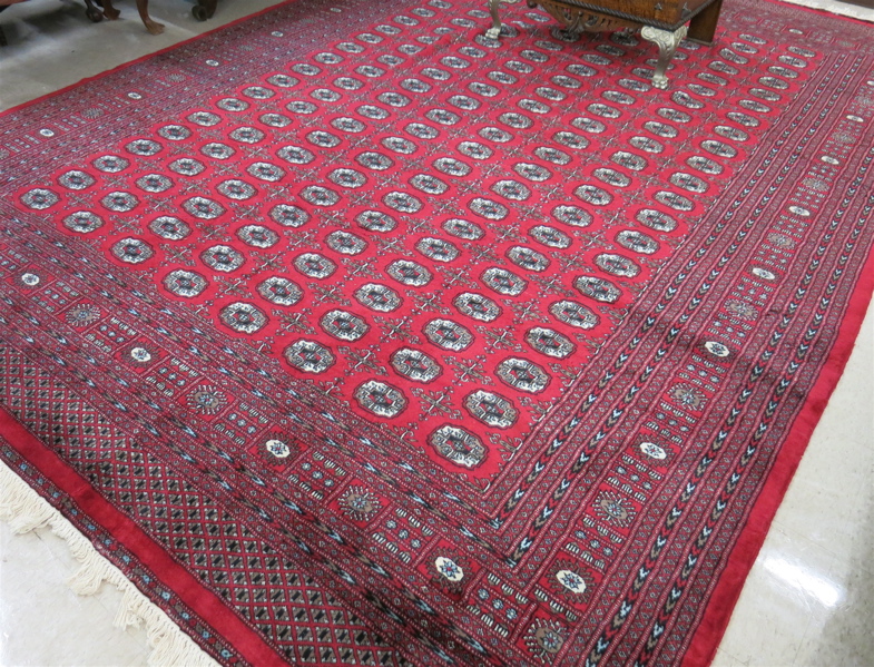 Appraisal: SIGNED RED FIELD BOKHARA CARPET India or Pakistan repeating columns