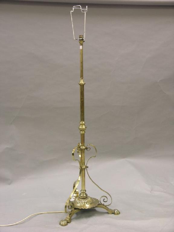 Appraisal: A brass standard lamp on triform base -