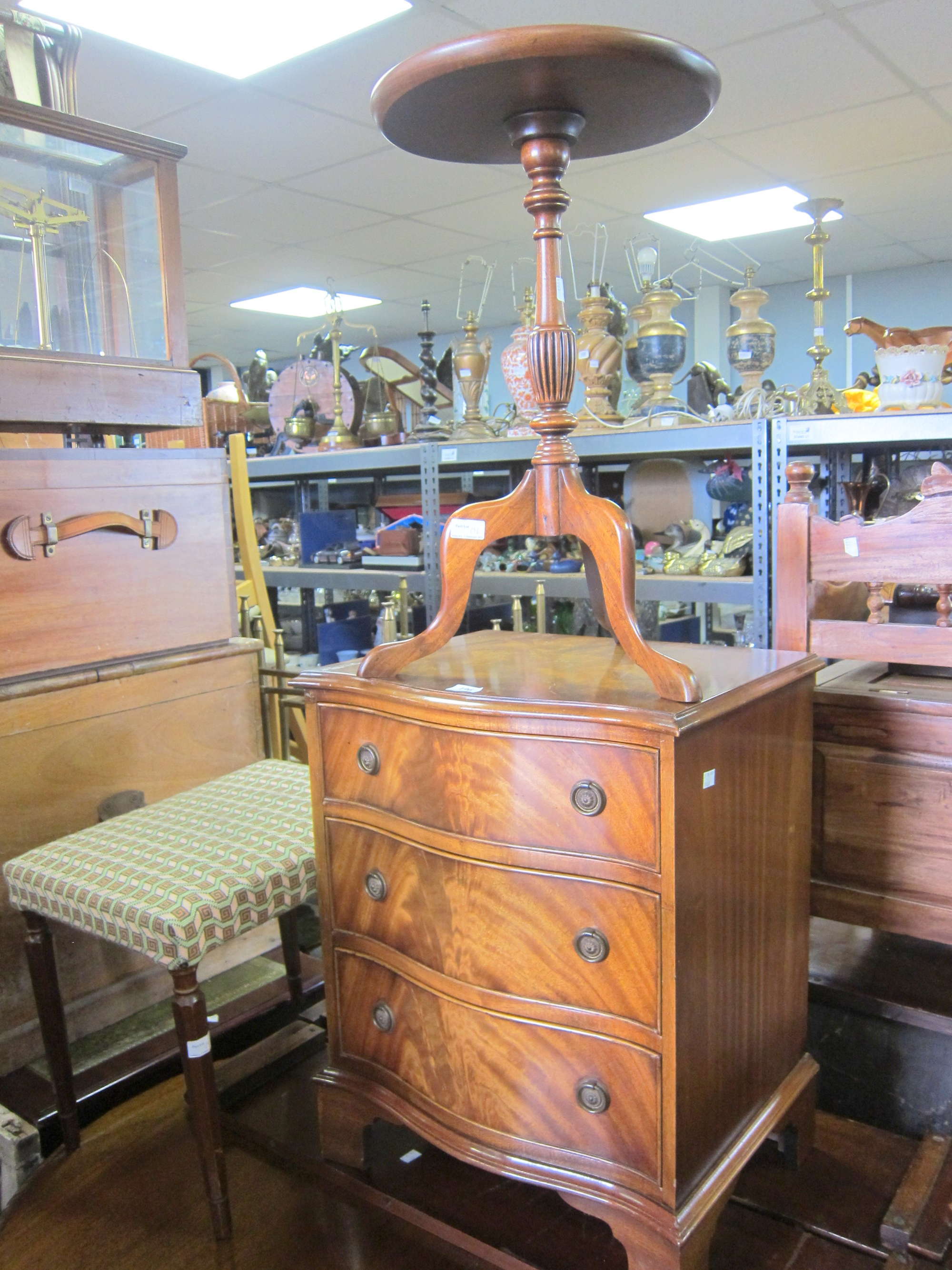 Appraisal: Mahogany serpentine chest a wine table a mahogany trolley and