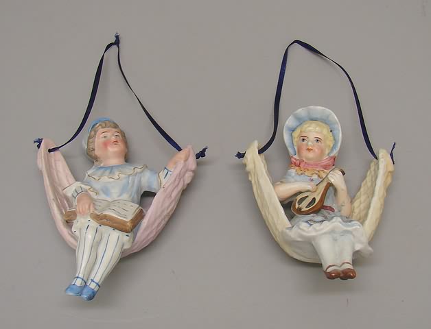 Appraisal: Pair of German bisque Swing figurines Children sitting in what