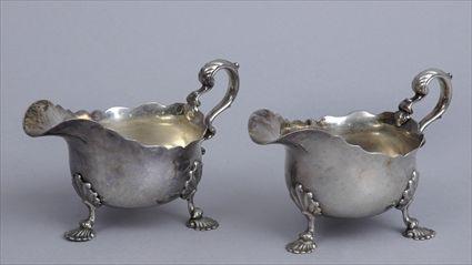 Appraisal: PAIR OF GEORGE III-STYLE ENGLISH SILVER TRIPOD SAUCE BOATS London