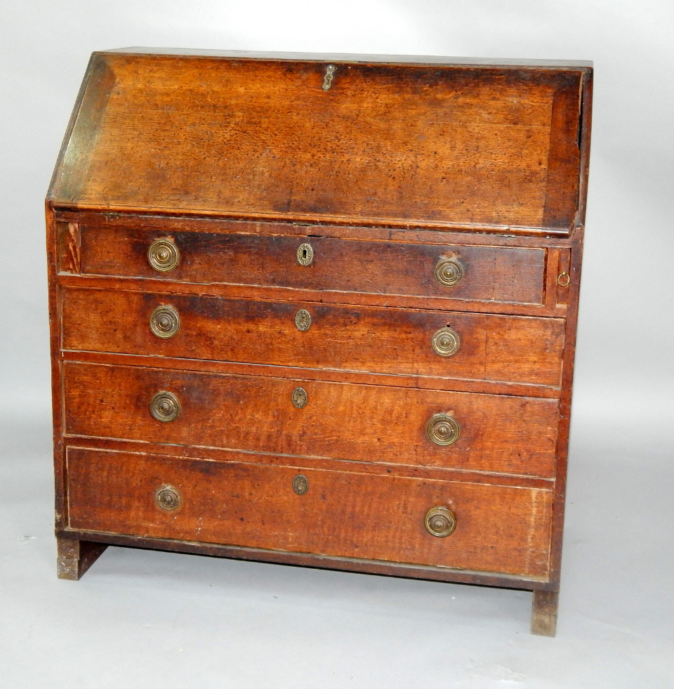 Appraisal: A George III oak bureau fall flap opening to reveal