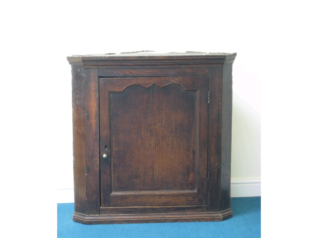 Appraisal: An antique oak hanging Corner Cupboard with single panelled door