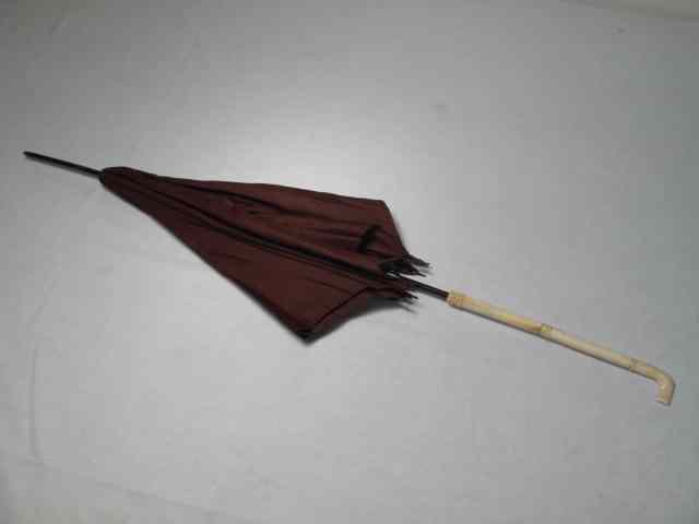 Appraisal: Antique brown silk parasol with carved bone handle Good condition