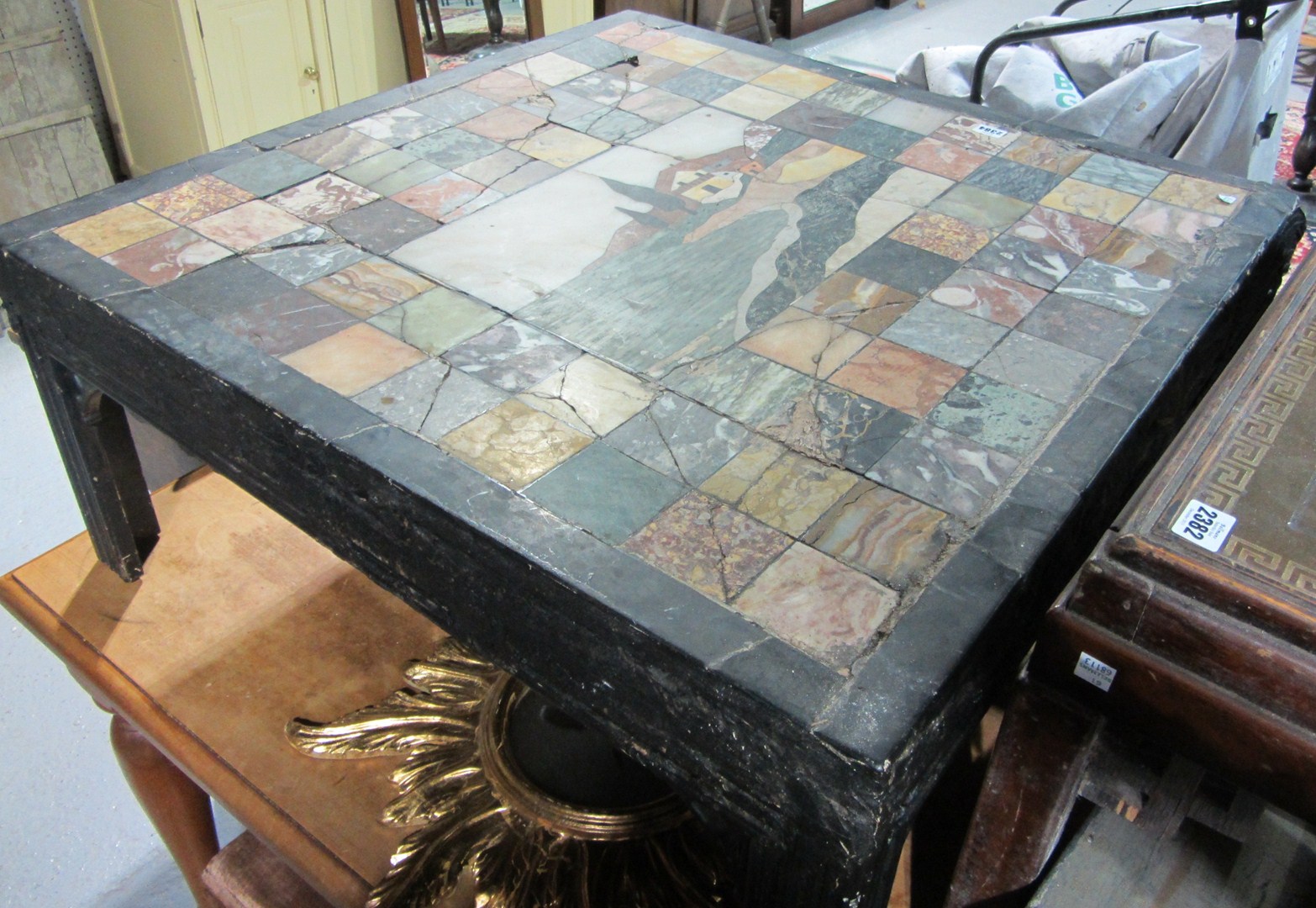 Appraisal: A th century ebonised low coffee table with specimen marble