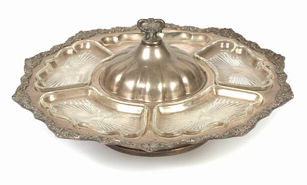 Appraisal: A plated revolving tray with partial glass fittings Shaped circular