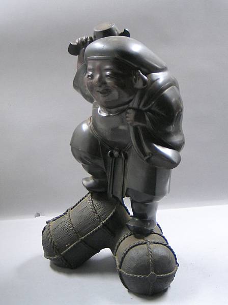 Appraisal: A patinated metal figure of Daikoku Standing on saparately cast