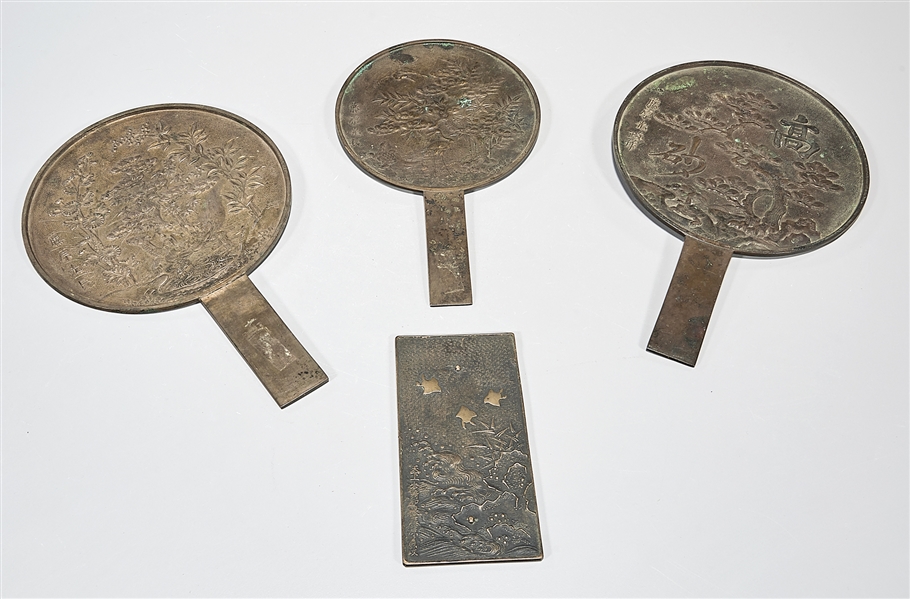 Appraisal: Four Japanese bronze hand mirrors with flower and bird designs