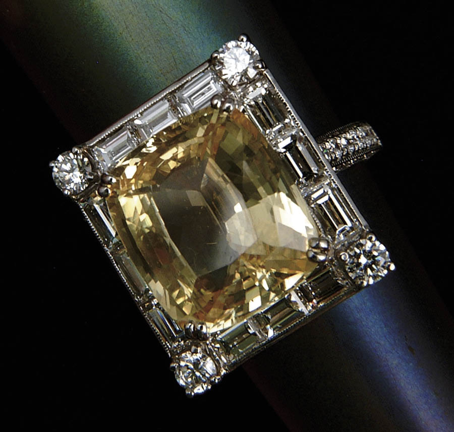 Appraisal: YELLOW SAPPHIRE AND DIAMOND RING Spectacular platinum ring has center