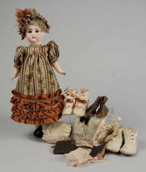 Appraisal: German Bisque Child Doll with Accessories Description Bisque socket head