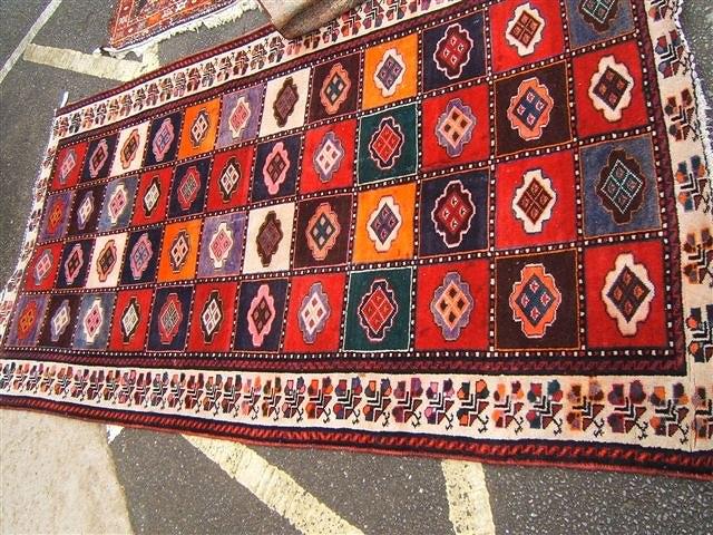 Appraisal: Persian rug with checkered pattern to the middle and floral