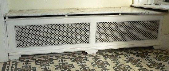 Appraisal: Two twin panelled pierced cast radiator surrounds with marble tops