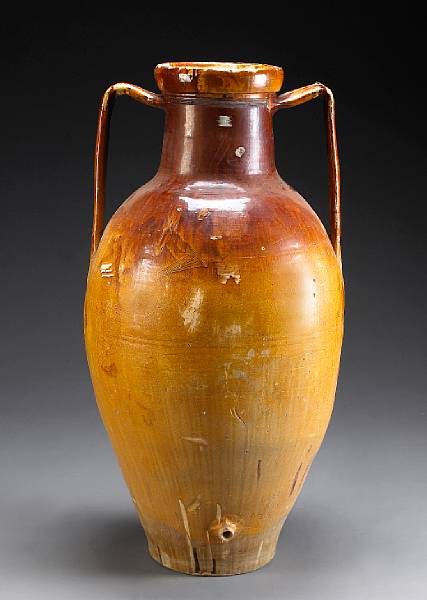 Appraisal: A brown glazed terracotta amphora Of baluster form with two