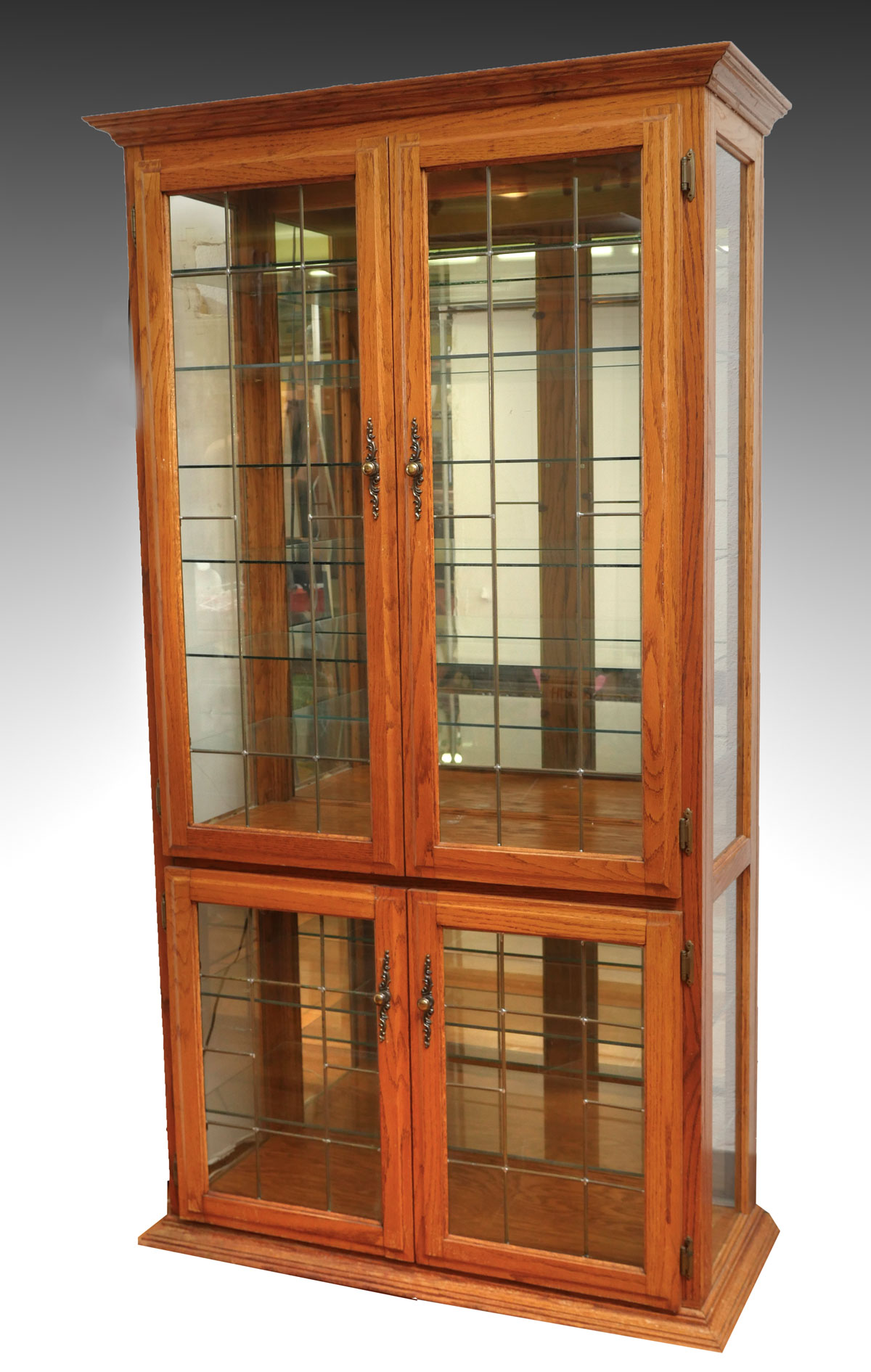 Appraisal: GOLDEN OAK DISPLAY CASE Oak framed door glass display cabinet