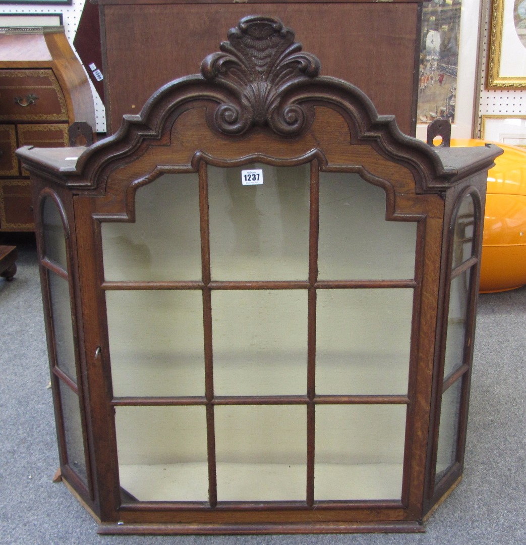 Appraisal: An th century Dutch oak hanging cupboard with bonnet top