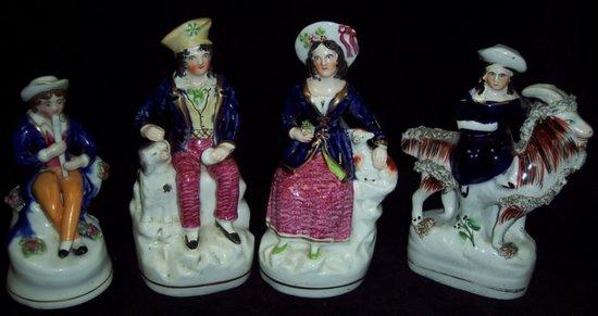 Appraisal: A pair of Staffordshire figures gentleman with companion each with