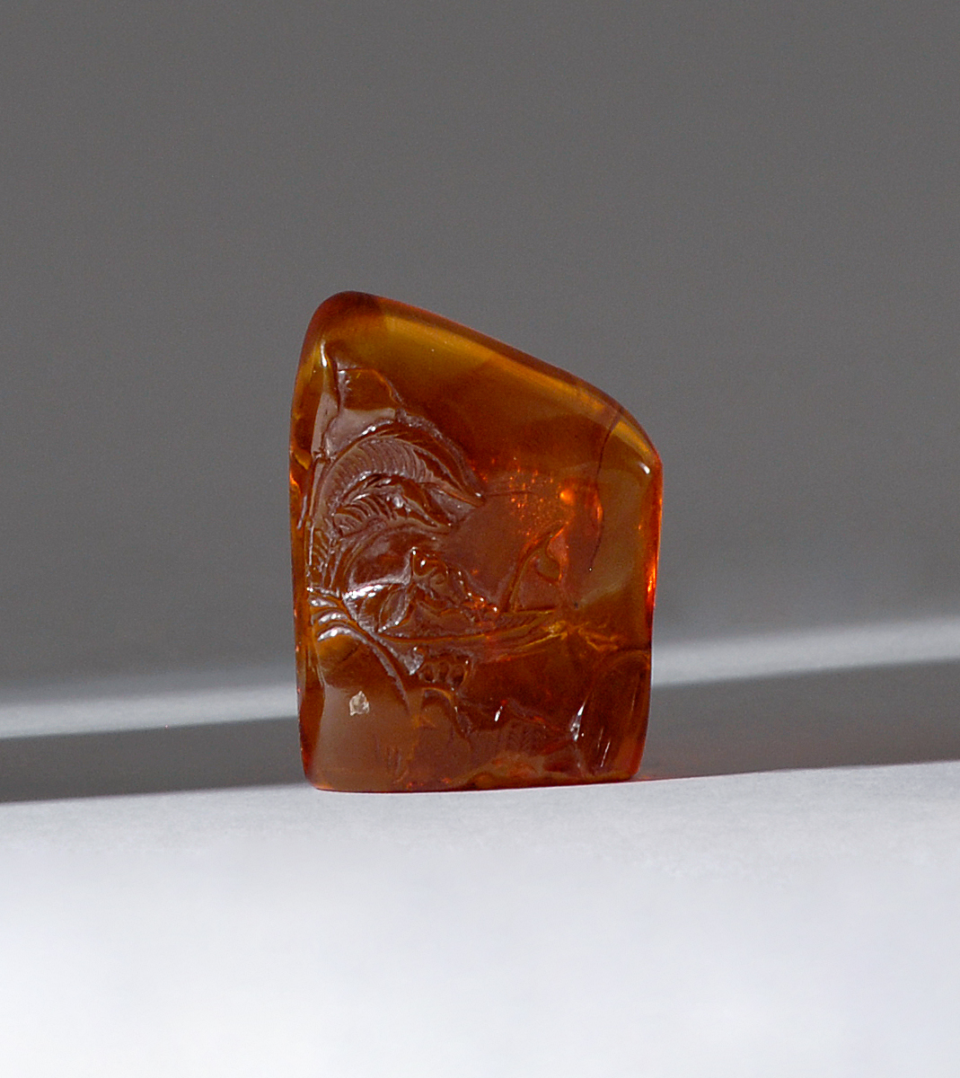 Appraisal: AMBER SEAL th CenturyIn mountain form with river landscape carving