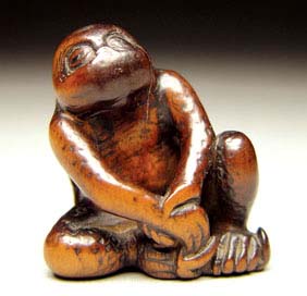 Appraisal: ANTIQUE WOOD NETSUKE Antique carved wood netsuke of a crouched