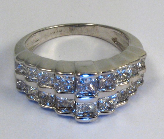 Appraisal: DIAMOND AND FOURTEEN KARAT WHITE GOLD RING set with princess-cut