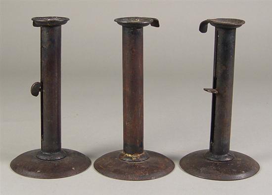 Appraisal: Three Hog Scraper Push-up Candlesticks Late 's Matching iron candlesticks