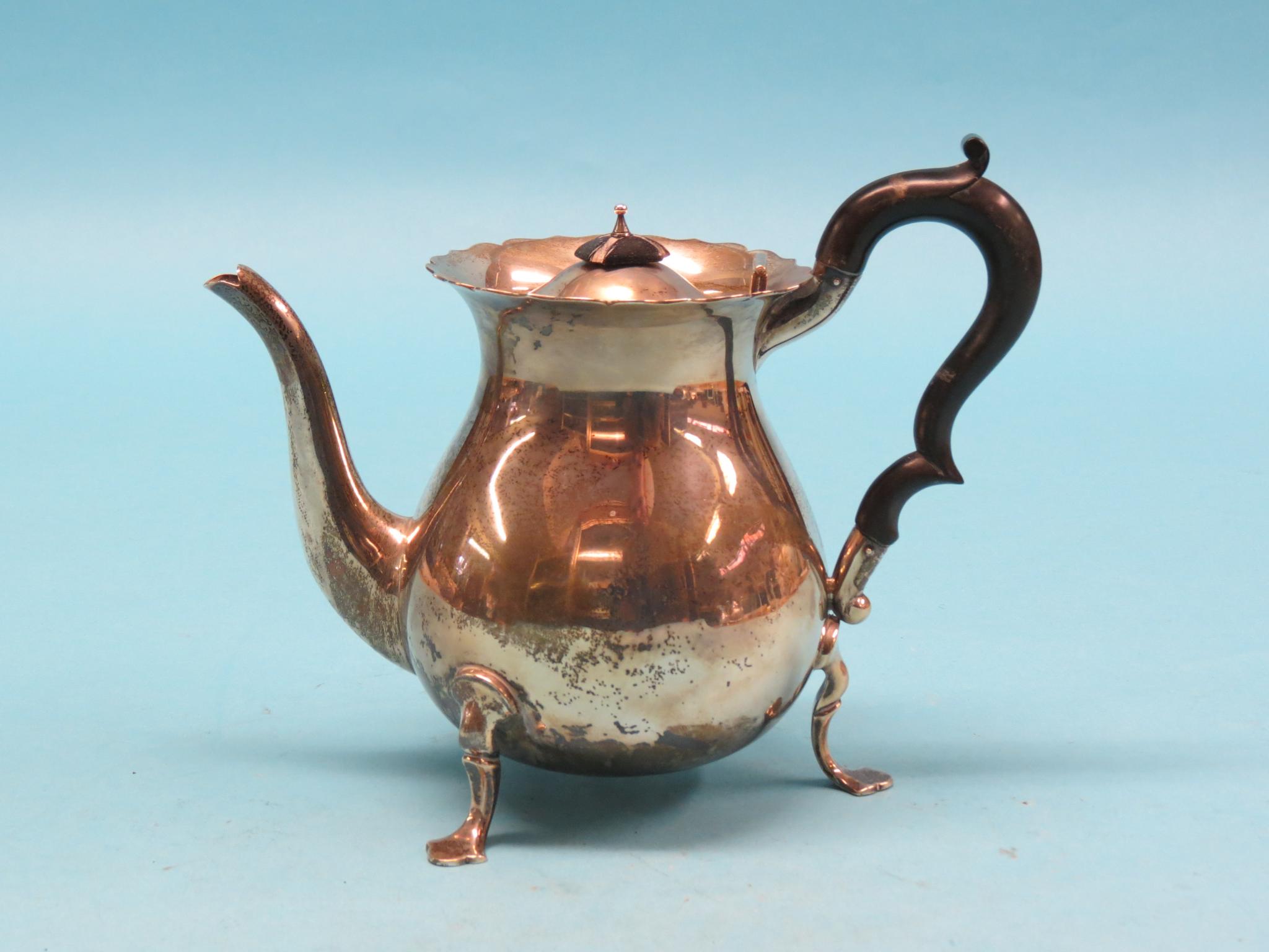 Appraisal: A silver teapot bulbous-shape with black wood handle scroll feet