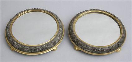 Appraisal: PAIR OF RENAISSANCE-STYLE BRASS AND SILVER-PLATED MIRROR PLATEAUX Each circular