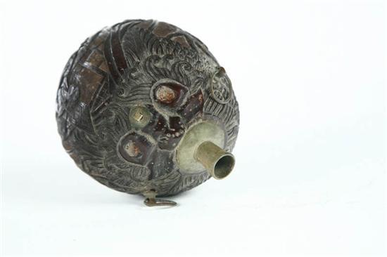 Appraisal: TWO SCRIMSHAW COCONUTS Carribean th century Includes a powder flask