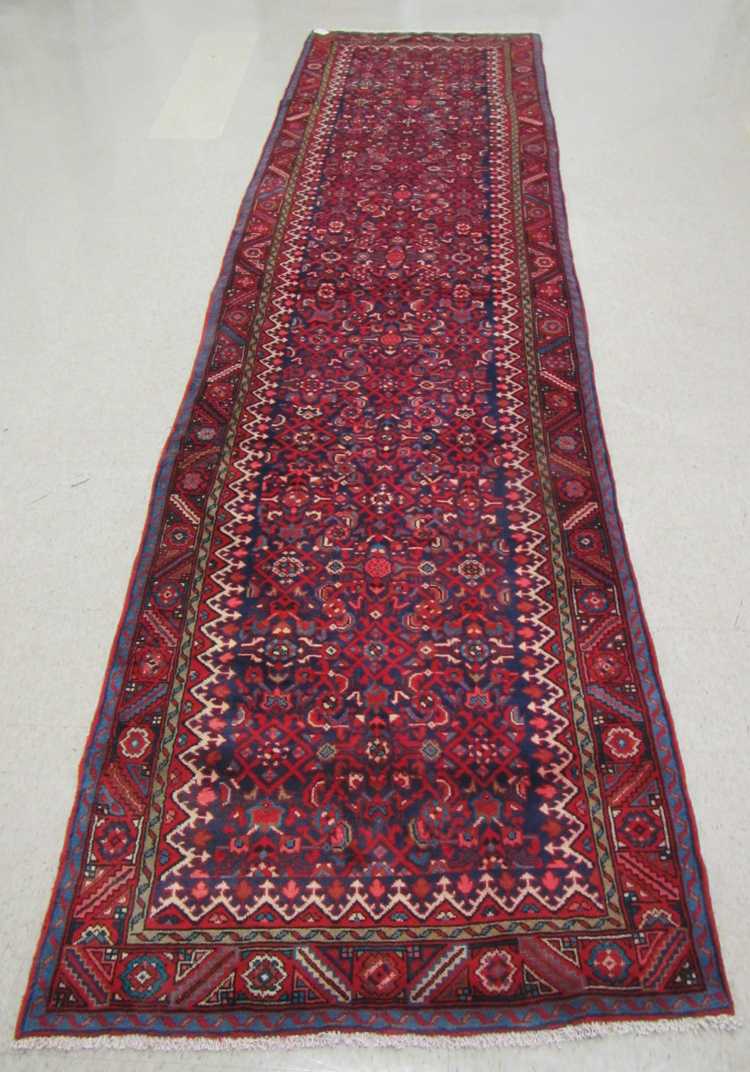 Appraisal: HAND KNOTTED PERSIAN HALL CARPET overall Herati floral design on