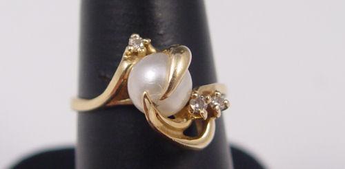 Appraisal: PEARL AND DIAMOND RING K yellow gold ring contains one