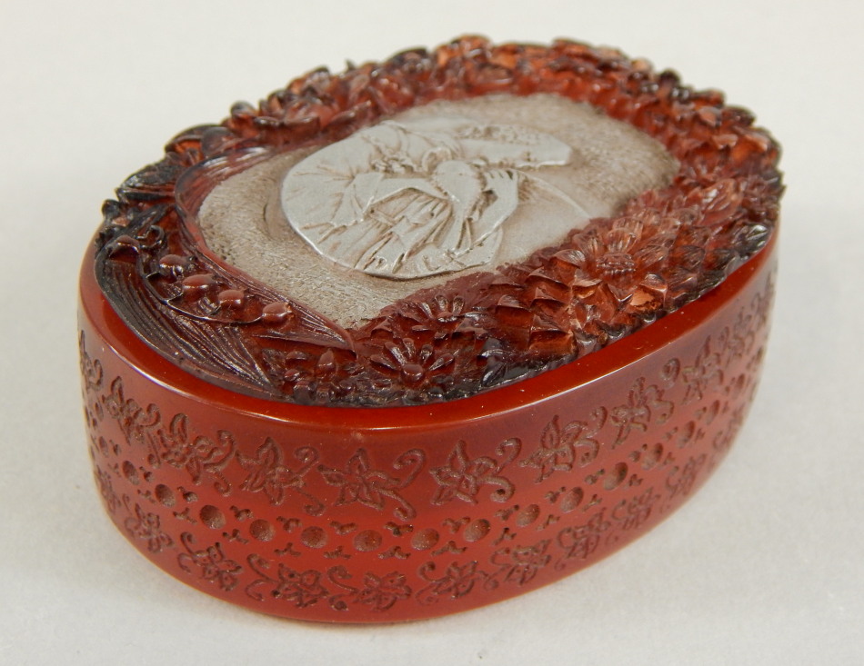 Appraisal: A French carved amber box and cover the lid inset