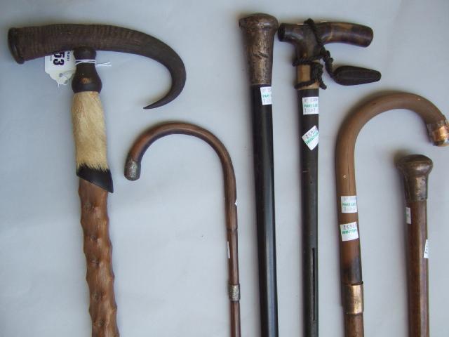 Appraisal: Two walking canes with silver pommels two walking sticks with