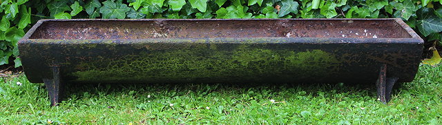 Appraisal: A SMALL CAST IRON PIG FEEDING TROUGH of half round