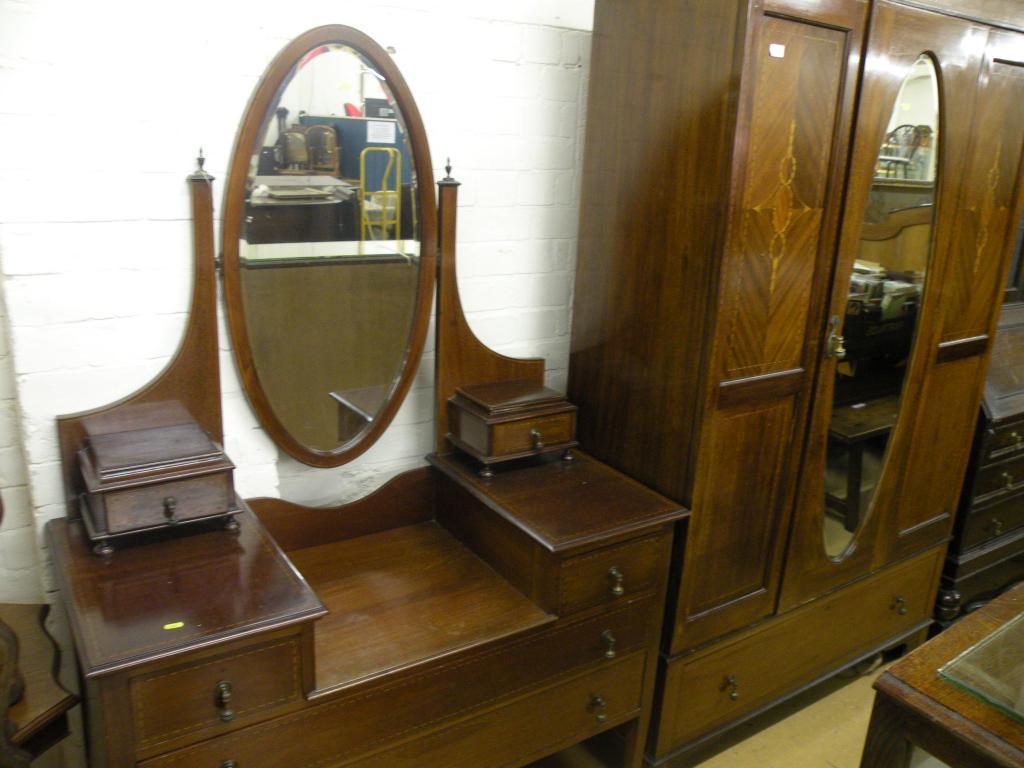 Appraisal: An Edwardian inlaid mahogany wardrobe with a single mirror door