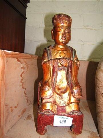 Appraisal: An antique carved Chinese polychrome wooden figure of a seated