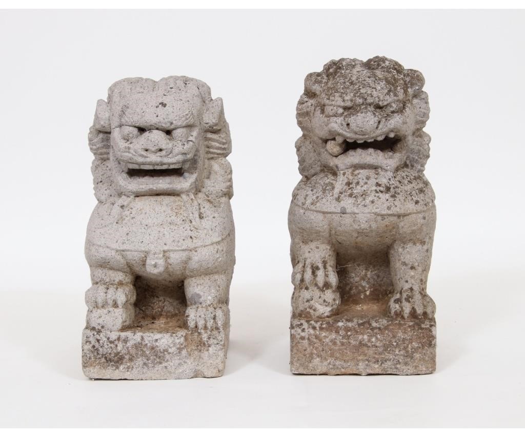 Appraisal: Two similar cast stone seated foo dogs th c h