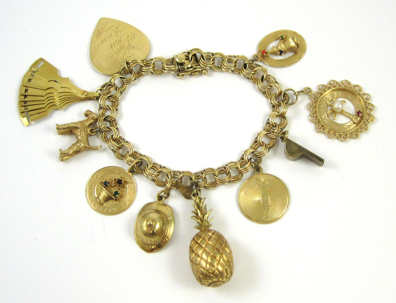 Appraisal: FOURTEEN KARAT YELLOW GOLD CHARM BRACELET The yellow gold chain