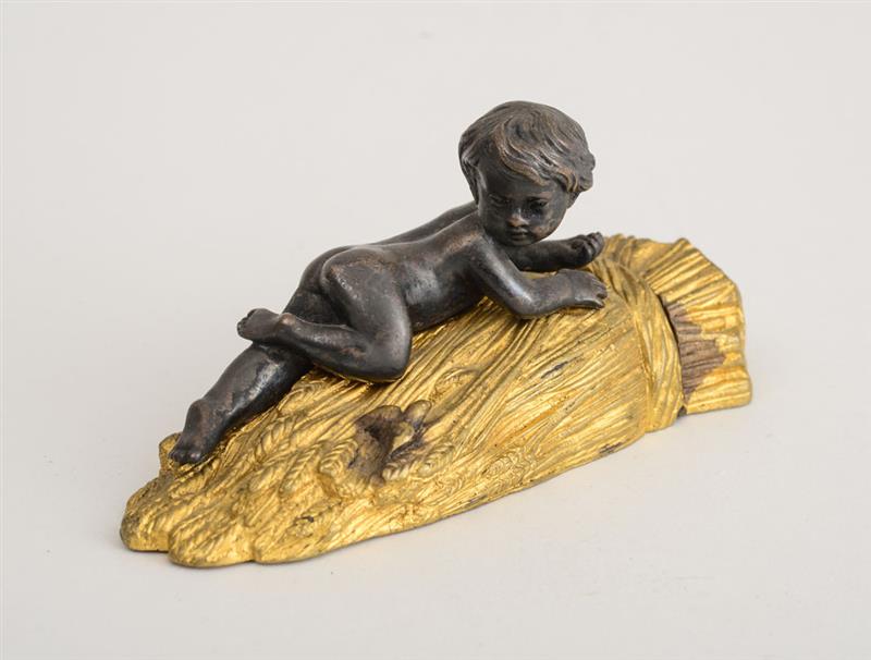 Appraisal: FRENCH BRONZE AND GILT-METAL BOX Modeled with a putto gazing