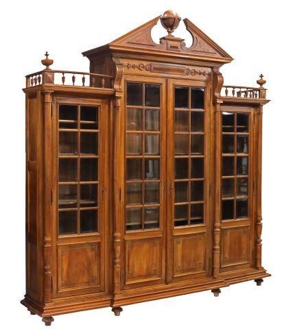 Appraisal: Continental carved walnut breakfront bookcase th c having split pediment